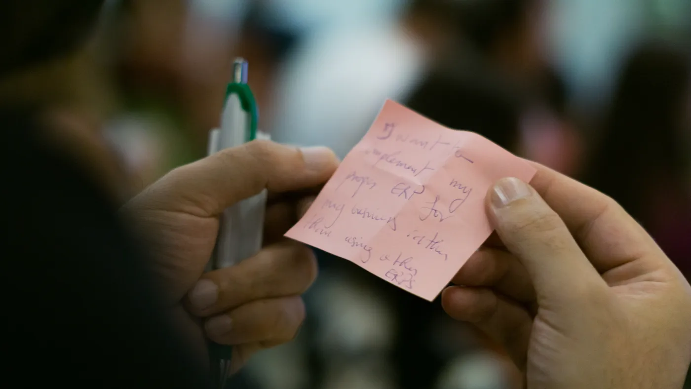 A guest holding their note during a networking game