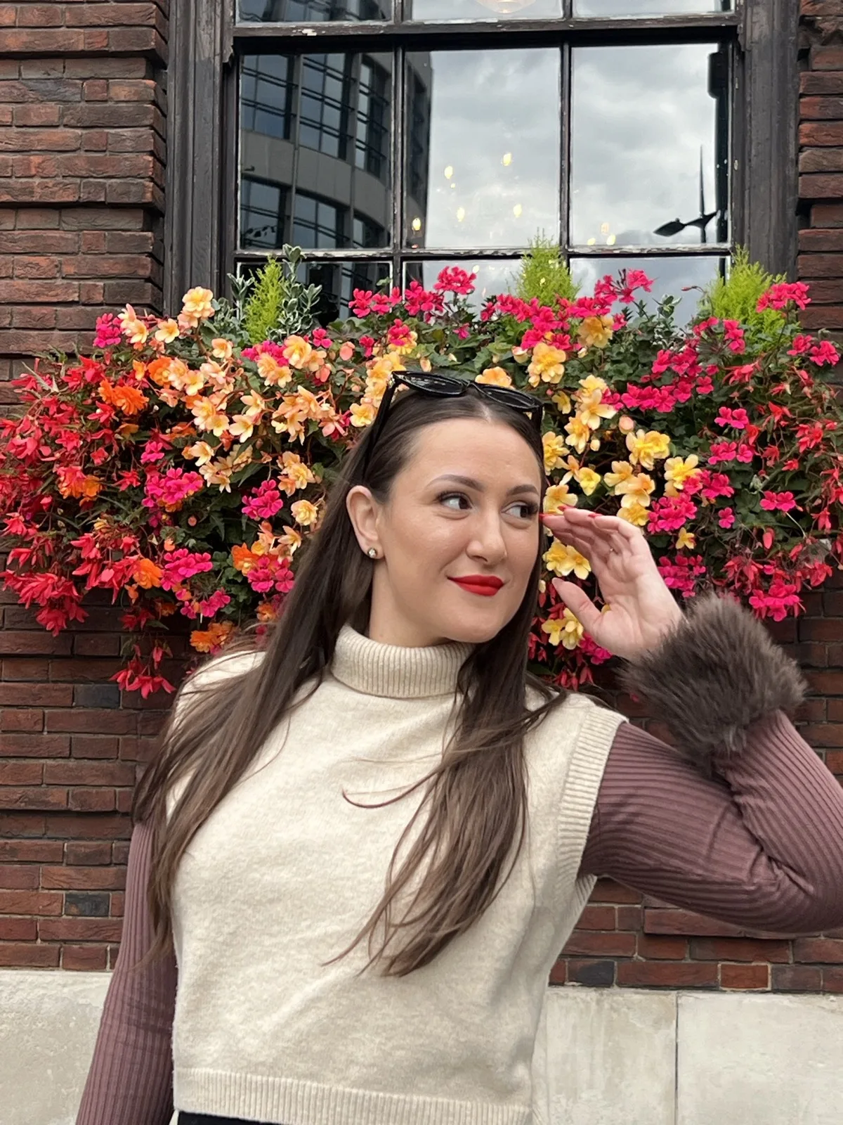 Elsi in front of a flower box in London