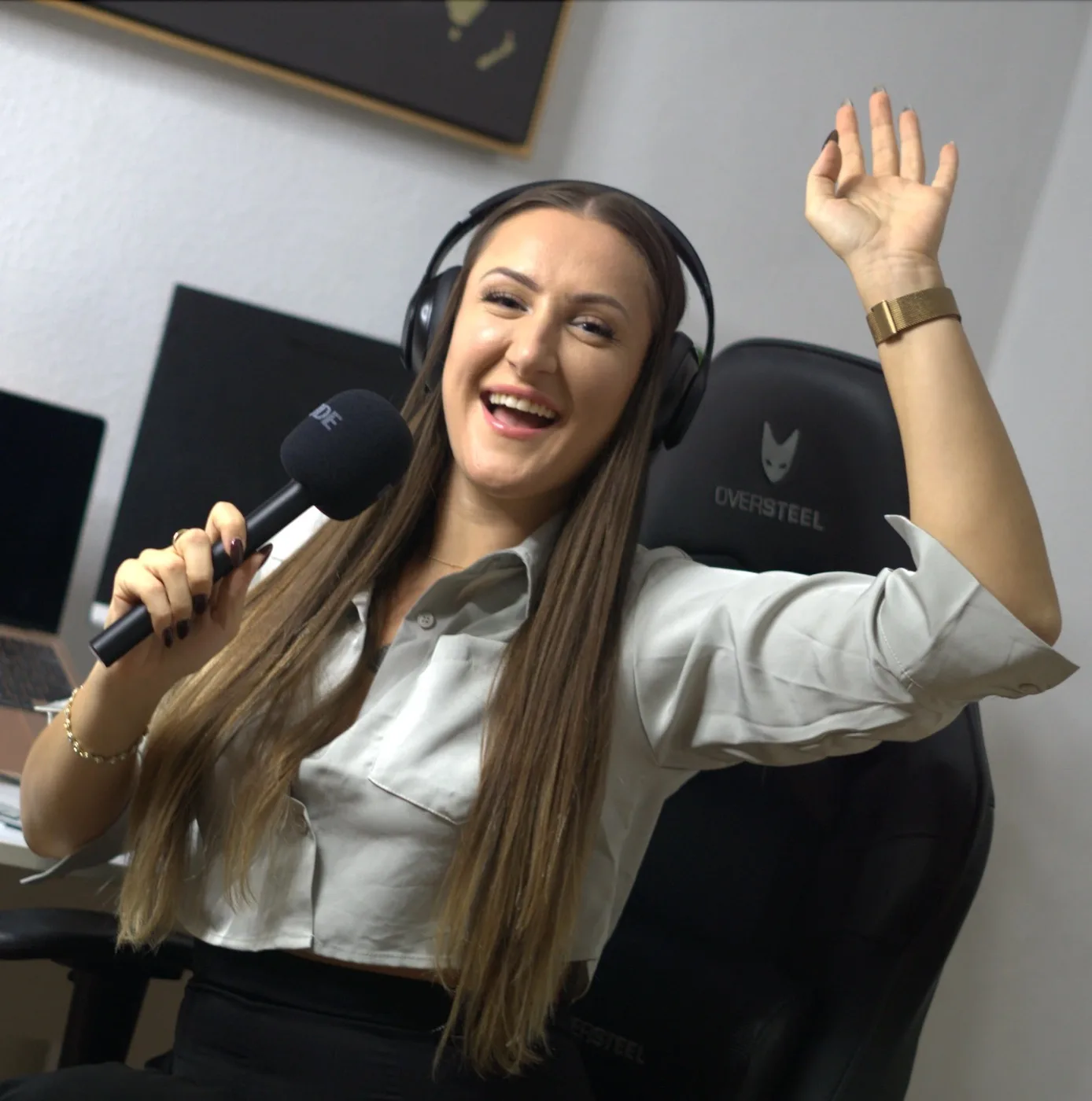 Elsi laughing into a microphone in her studio